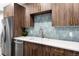 Close-up of kitchen featuring modern cabinetry, stainless steel appliances, and sleek backsplash at 1308 Stuart St, Denver, CO 80204