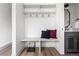 Charming mudroom with built-in bench, storage, and convenient access to a half bath at 1308 Stuart St, Denver, CO 80204