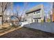 Spacious backyard featuring a lawn area, white fence, and mature trees, perfect for outdoor enjoyment at 780 Utica Ave, Boulder, CO 80304