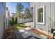 Landscaped backyard with a stone pathway, garden bed, and white fence at 780 Utica Ave, Boulder, CO 80304
