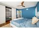 Bedroom featuring built-in closet, ceiling fan, and ensuite bathroom entrance for a modern, functional space at 780 Utica Ave, Boulder, CO 80304