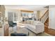 Open floor plan with living room, kitchen, and staircase featuring hardwood floors and access to backyard at 780 Utica Ave, Boulder, CO 80304