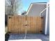 Wooden fence gate providing access to the backyard, offering security and privacy at 19038 E Girard Ave, Aurora, CO 80013