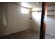Unfinished basement space with some shelving and a single window at 19038 E Girard Ave, Aurora, CO 80013