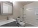 Well-lit bathroom featuring a tub-shower combo, modern vanity, and neutral finishes at 19038 E Girard Ave, Aurora, CO 80013