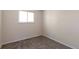 Small bedroom with a window, carpet, and neutral walls at 19038 E Girard Ave, Aurora, CO 80013
