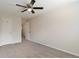 A carpeted bedroom featuring a ceiling fan and multiple doors to other rooms at 19038 E Girard Ave, Aurora, CO 80013