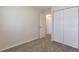 Bedroom with carpeted floors, a closet, and an open doorway to another room at 19038 E Girard Ave, Aurora, CO 80013