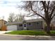 Cozy single-story home featuring a well-kept lawn, a garage, and mature trees at 19038 E Girard Ave, Aurora, CO 80013