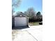 Detached garage with a large garage door and parking area in the backyard at 19038 E Girard Ave, Aurora, CO 80013