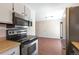Kitchen with stainless steel appliances, white cabinets, and laminate countertops at 19038 E Girard Ave, Aurora, CO 80013