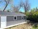 Exterior view of the backyard storage shed with a side door and two windows at 19038 E Girard Ave, Aurora, CO 80013