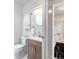 Modern powder room with stylish vanity, gold fixtures, and sleek design elements at 3071 W 38Th Ave, Denver, CO 80211