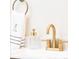Close-up of bathroom sink featuring gold faucet, soap dispenser, and a towel at 3071 W 38Th Ave, Denver, CO 80211
