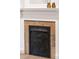 Close-up of an ornate fireplace with detailed carvings and decorative accents at 3071 W 38Th Ave, Denver, CO 80211