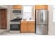 Bright kitchen with stainless steel appliances, light wood cabinets, white countertops and modern finishes at 3071 W 38Th Ave, Denver, CO 80211