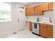 Bright kitchen with a door to the outside, new appliances, white countertops and light wood cabinets at 3071 W 38Th Ave, Denver, CO 80211