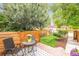 Outdoor patio with chairs and a table, surrounded by wood fencing and landscaping at 3071 W 38Th Ave, Denver, CO 80211