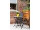 Cozy patio with a metal table and chairs, and flower pot in front of a brick wall at 3071 W 38Th Ave, Denver, CO 80211