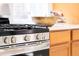 Close-up of a stainless steel gas range with white countertops and light wood cabinets in a modern kitchen at 3071 W 38Th Ave, Denver, CO 80211