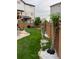 Landscaped backyard featuring a lush lawn, stone pathway, rock garden, and wooden fence at 10232 Yampa Ct, Commerce City, CO 80022