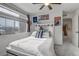Bright bedroom with a comfortable bed, art and large window at 10232 Yampa Ct, Commerce City, CO 80022