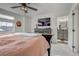 Bedroom featuring a TV, ensuite bathroom, and calming color scheme at 10232 Yampa Ct, Commerce City, CO 80022