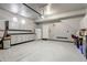 Spacious garage with epoxy floors, built in cabinets, counter space and refrigerator at 10232 Yampa Ct, Commerce City, CO 80022