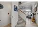 Hallway with stairs leading to upper floor, half bath, and a view of living room at 10232 Yampa Ct, Commerce City, CO 80022