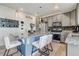 Stylish kitchen featuring gray cabinets, stainless steel appliances, and a large island with seating at 10232 Yampa Ct, Commerce City, CO 80022
