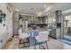 Modern kitchen with a center island, granite counters and gray cabinets at 10232 Yampa Ct, Commerce City, CO 80022
