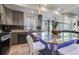 Modern kitchen with a granite island, gray cabinets, stainless steel appliances, and lots of natural light at 10232 Yampa Ct, Commerce City, CO 80022