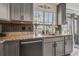 Kitchen counter with a stainless steel sink, faucet and black backsplash at 10232 Yampa Ct, Commerce City, CO 80022