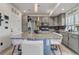 Bright kitchen with a large center island, stainless appliances and gray cabinets at 10232 Yampa Ct, Commerce City, CO 80022