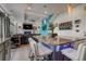 Open concept kitchen with granite counters, island seating, and view of the living room with a fireplace at 10232 Yampa Ct, Commerce City, CO 80022