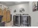 Well-organized laundry room featuring modern black washer and dryer at 10232 Yampa Ct, Commerce City, CO 80022
