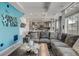 Open concept living room with a large sectional couch and an adjacent kitchen at 10232 Yampa Ct, Commerce City, CO 80022