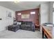 Comfortable living room with a cozy sofa, plush carpet, and accent wall at 10232 Yampa Ct, Commerce City, CO 80022