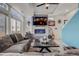 Comfortable living room featuring a stone fireplace, large TV, and a cozy sectional sofa at 10232 Yampa Ct, Commerce City, CO 80022