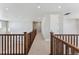 Upstairs hallway with wood railings and carpeted flooring at 9349 Russell Cir, Arvada, CO 80007