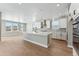 Spacious kitchen with white cabinets, island, and stainless steel appliances at 9349 Russell Cir, Arvada, CO 80007