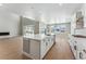 Modern kitchen with island, white cabinets, and quartz countertops at 9349 Russell Cir, Arvada, CO 80007