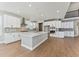 Modern kitchen with white cabinets, stainless steel appliances and island at 9349 Russell Cir, Arvada, CO 80007