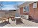 Inviting back patio with a vintage water trough tub, chairs, and a red brick exterior at 748 S Grape St, Denver, CO 80246