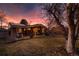 Sprawling backyard showcasing a covered patio, inviting deck, green lawn, and mature trees for outdoor enjoyment at 748 S Grape St, Denver, CO 80246