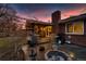 Well-maintained backyard featuring a covered patio, a stainless steel grill, and a cozy fire pit area for entertaining at 748 S Grape St, Denver, CO 80246