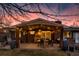 Inviting outdoor space with a covered patio featuring exposed wooden beams, string lights, and an al fresco dining table at 748 S Grape St, Denver, CO 80246