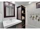 Well-maintained bathroom includes ample storage and a mosaic tile floor at 748 S Grape St, Denver, CO 80246