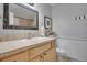 Bathroom featuring a granite countertop, decorative mirror, and neutral color palette at 748 S Grape St, Denver, CO 80246