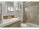 Stylish bathroom with neutral tile, modern sink, and glass shower enclosure at 748 S Grape St, Denver, CO 80246